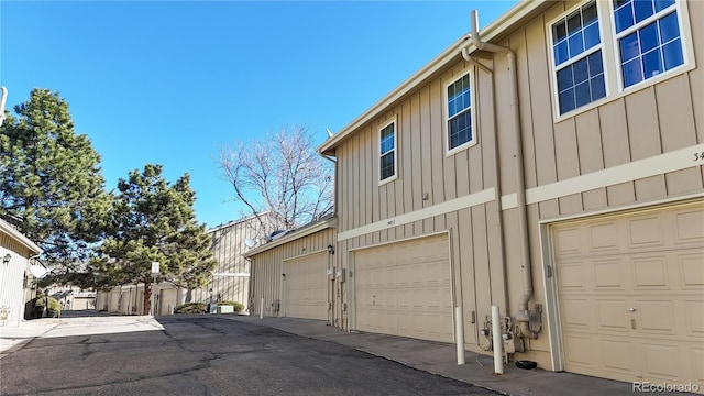 view of side of home featuring a garage and board and batten siding