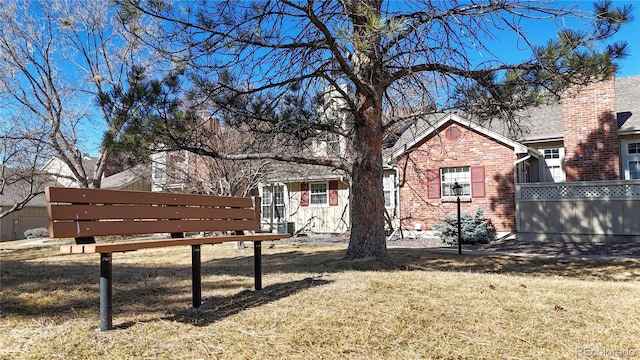 view of front of home featuring a front lawn and brick siding