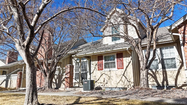 view of front of property featuring roof with shingles and central air condition unit