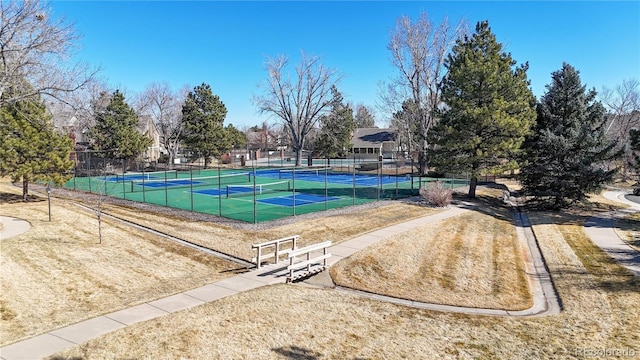 view of pool featuring a tennis court and fence