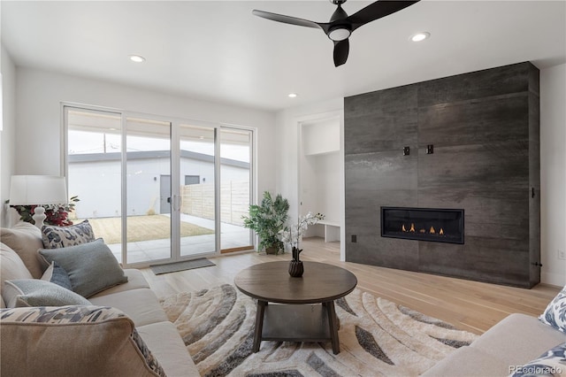 1953 W 47th Ave, Denver, CO 80211 - living area featuring a tiled fireplace, recessed lighting, ceiling fan, and wood finished floors