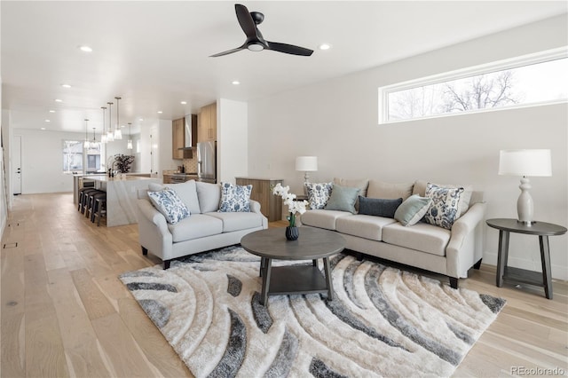 1953 W 47th Ave, Denver, CO 80211 - living area with a ceiling fan, recessed lighting, plenty of natural light, and light wood-style floors