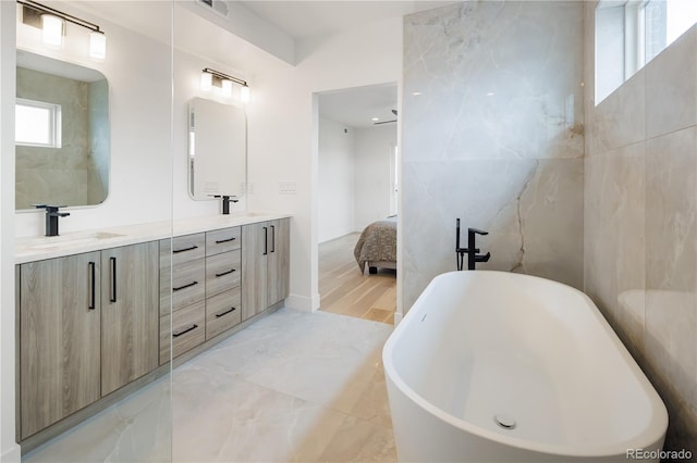1953 W 47th Ave, Denver, CO 80211 - ensuite bathroom featuring double vanity, visible vents, a sink, a soaking tub, and ensuite bath