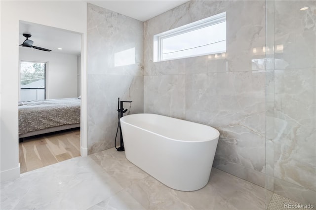 1953 W 47th Ave, Denver, CO 80211 - ensuite bathroom featuring ceiling fan, tile walls, marble finish floor, ensuite bathroom, and a soaking tub