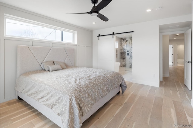 1953 W 47th Ave, Denver, CO 80211 - bedroom with recessed lighting, ceiling fan, a barn door, and light wood finished floors