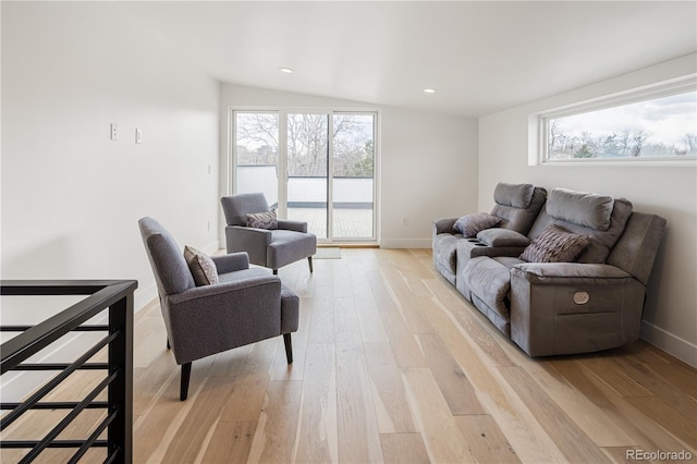 1953 W 47th Ave, Denver, CO 80211 - living area with light wood-style floors, baseboards, and a healthy amount of sunlight