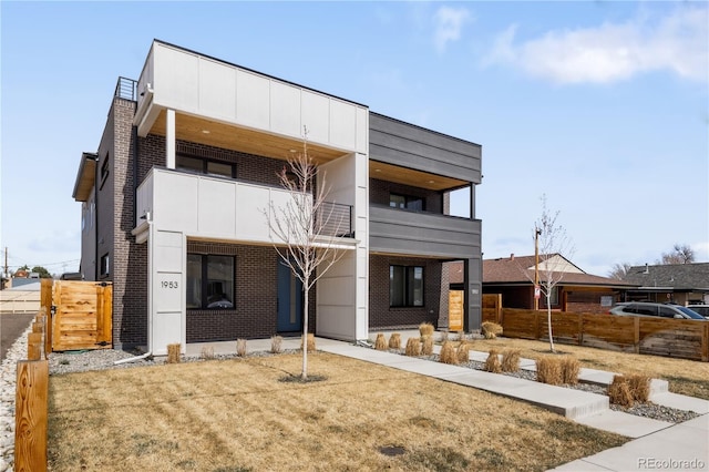1953 W 47th Ave, Denver, CO 80211 - view of front of home featuring brick siding, fence, and a balcony