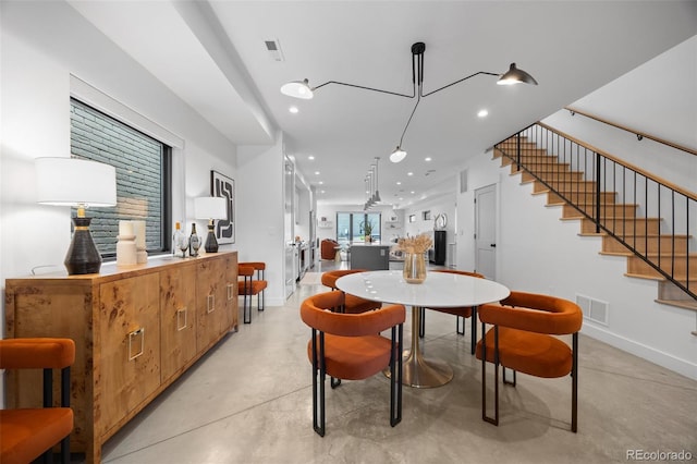 3409 Navajo St, Denver, CO 80211 - dining area with concrete floors, recessed lighting, baseboards, and stairs