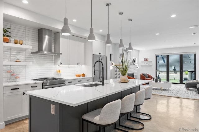 3409 Navajo St, Denver, CO 80211 - kitchen with wall chimney range hood, stainless steel appliances, a sink, open floor plan, and decorative backsplash
