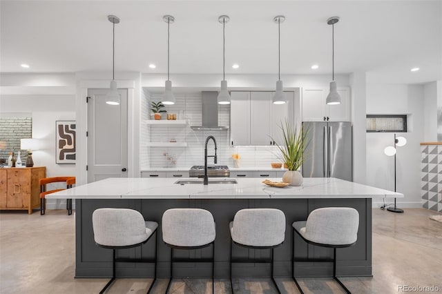 3409 Navajo St, Denver, CO 80211 - kitchen with freestanding refrigerator, finished concrete flooring, wall chimney exhaust hood, white cabinets, and a kitchen bar