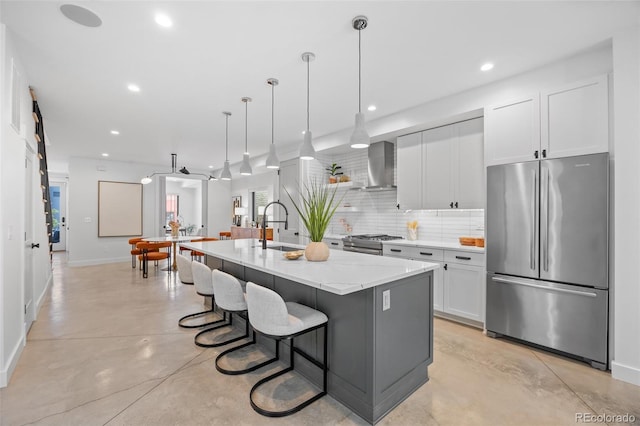 3409 Navajo St, Denver, CO 80211 - kitchen featuring appliances with stainless steel finishes, a sink, wall chimney range hood, baseboards, and concrete flooring