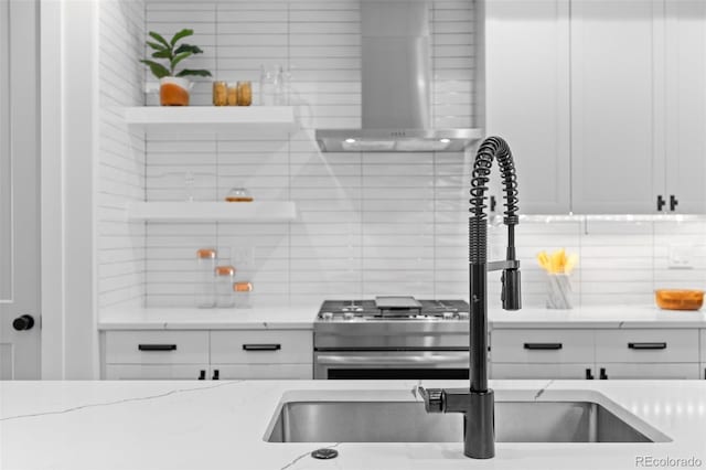 3409 Navajo St, Denver, CO 80211 - kitchen with wall chimney range hood, backsplash, open shelves, and white cabinets