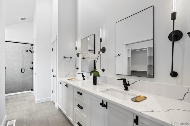3409 Navajo St, Denver, CO 80211 - full bath with a stall shower, double vanity, tile patterned flooring, and baseboards