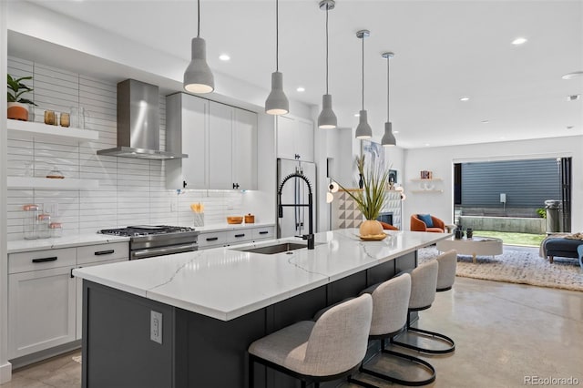 3409 Navajo St, Denver, CO 80211 - kitchen featuring wall chimney exhaust hood, gas stove, a sink, backsplash, and recessed lighting