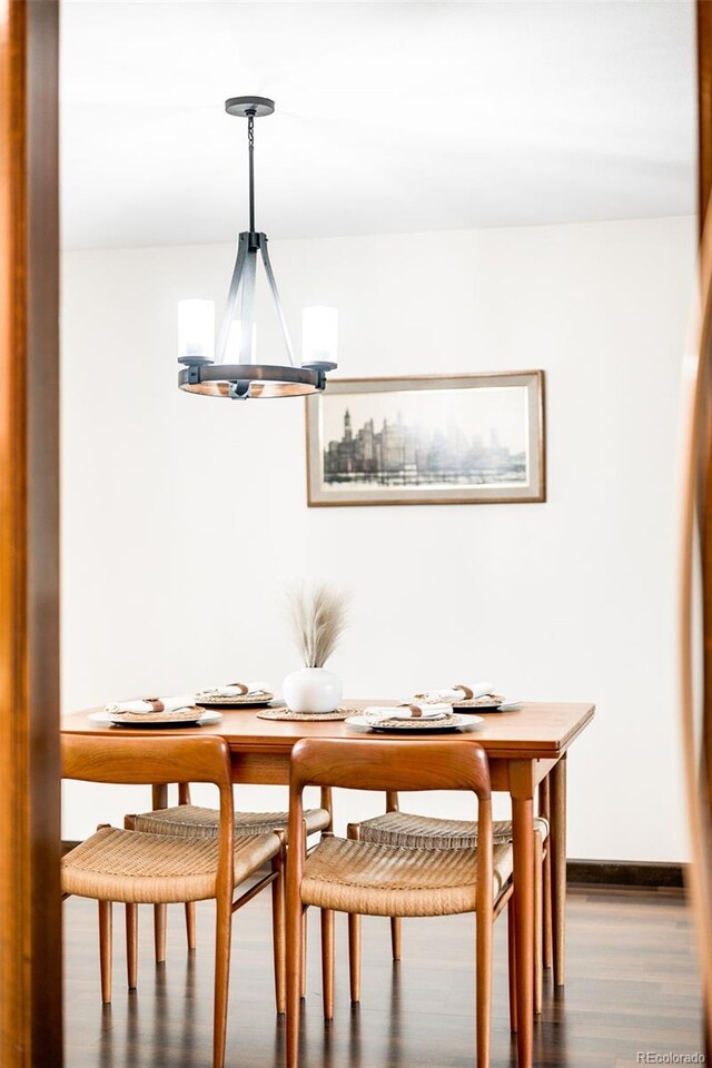 dining room with an inviting chandelier and wood finished floors