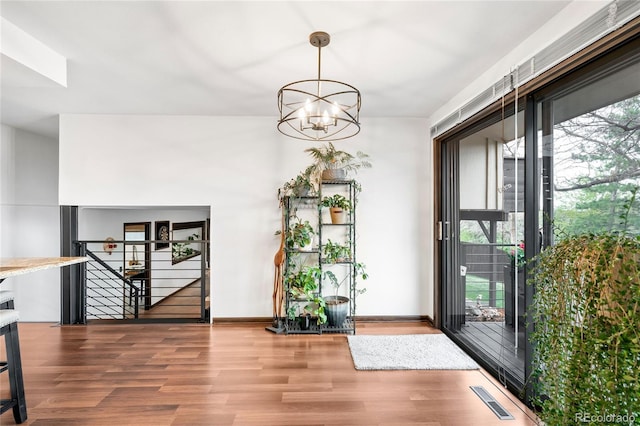 entryway featuring visible vents, a wealth of natural light, and wood finished floors
