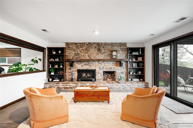 living room with carpet floors, visible vents, and a stone fireplace