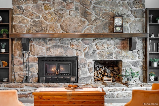 living room with a stone fireplace