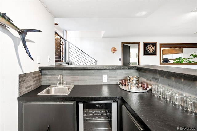 bar featuring a sink, wet bar, wine cooler, and decorative backsplash