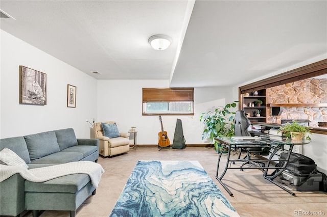living area featuring baseboards and visible vents