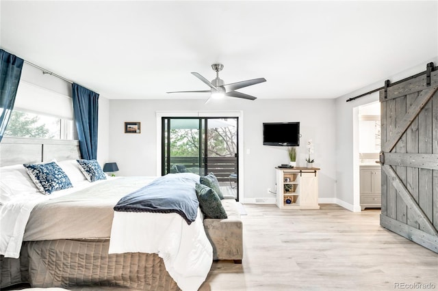 bedroom featuring light wood-style floors, a ceiling fan, a barn door, and access to exterior