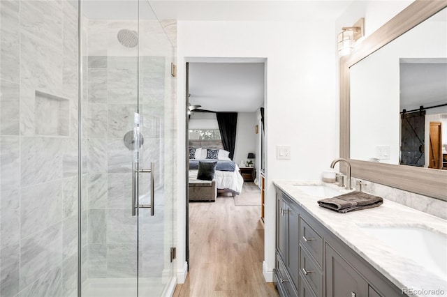 bathroom featuring a sink, a stall shower, ensuite bath, and double vanity