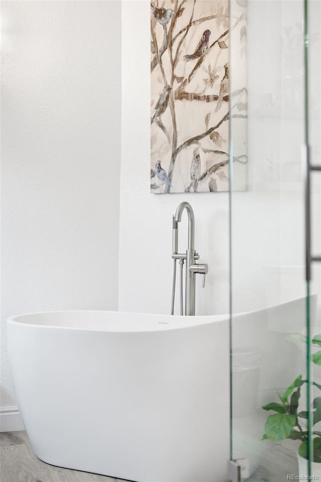 bathroom featuring a freestanding bath and a stall shower