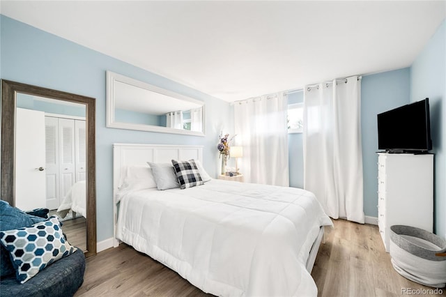 bedroom featuring baseboards and wood finished floors