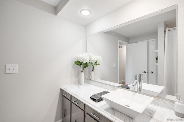 bathroom featuring baseboards and vanity