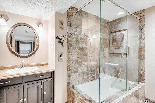 bathroom featuring vanity, tiled shower / bath combo, and a textured ceiling