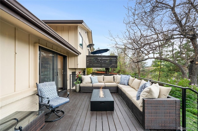 wooden terrace featuring outdoor lounge area