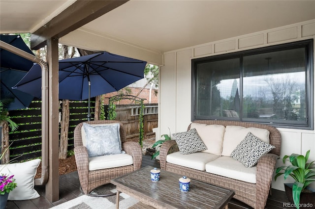 exterior space with outdoor lounge area and fence