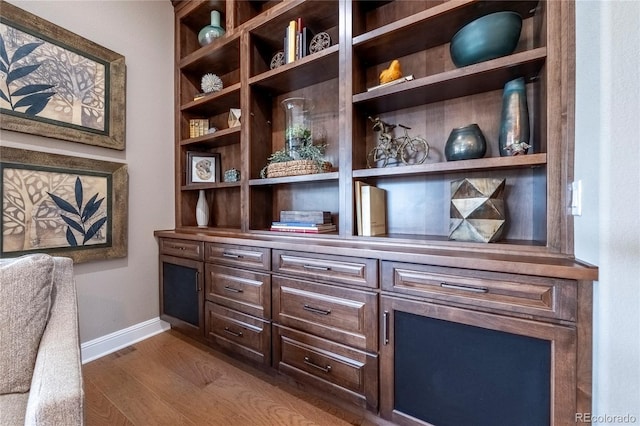 room details with baseboards and wood finished floors