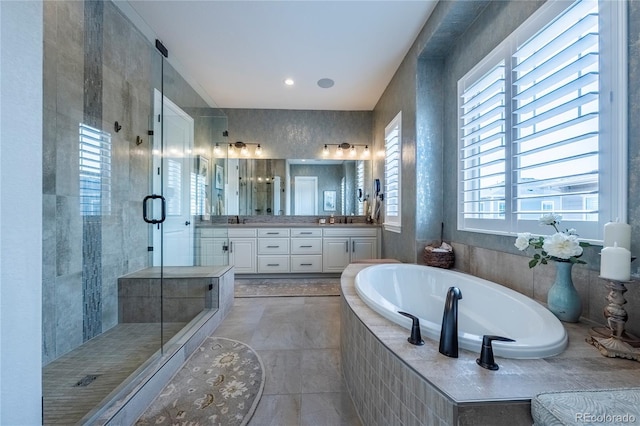 bathroom with a garden tub, vanity, and a shower stall