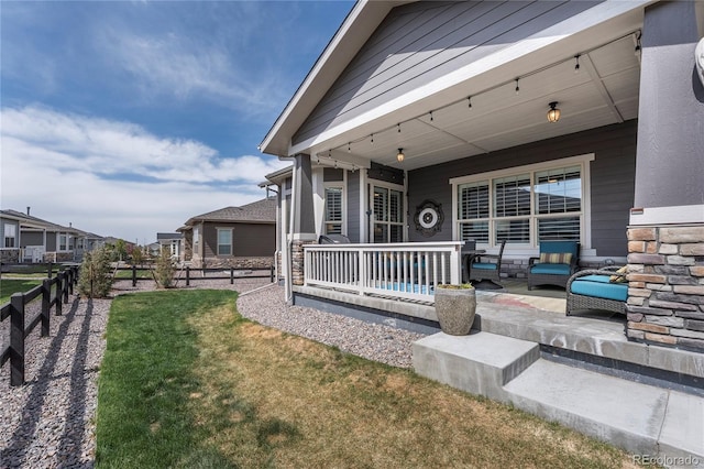 exterior space with fence, a yard, and covered porch