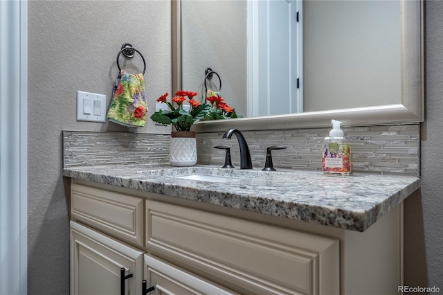 interior details with a textured wall and vanity