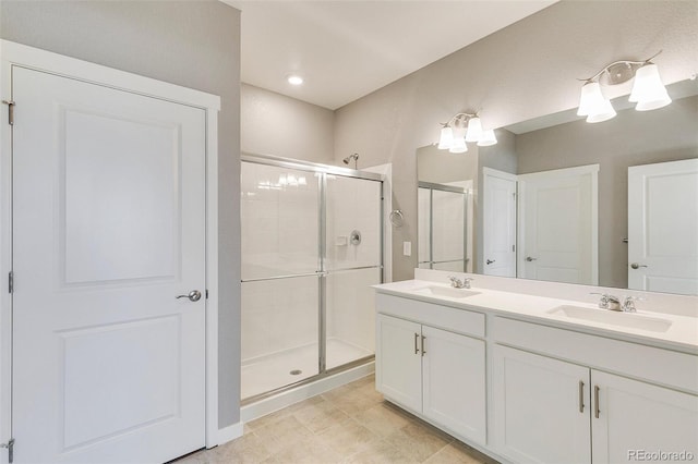 bathroom with vanity and a shower with shower door