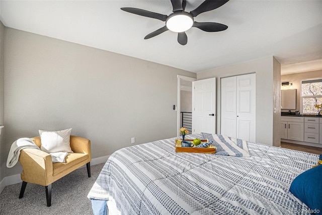 carpeted bedroom with baseboards, a closet, and ceiling fan