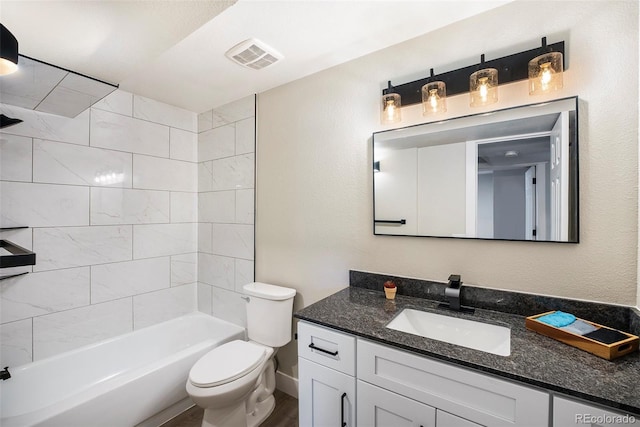 full bath with toilet, vanity, and bathing tub / shower combination