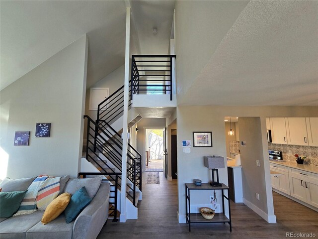 stairway with wood finished floors and baseboards