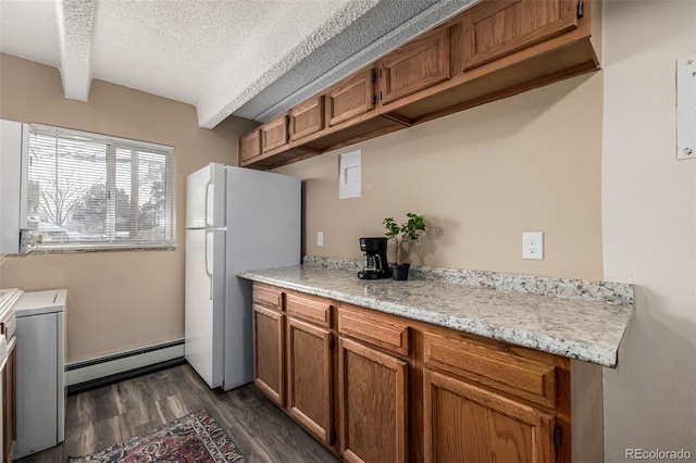 kitchen with a textured ceiling, dark hardwood / wood-style floors, white fridge, beamed ceiling, and a baseboard heating unit