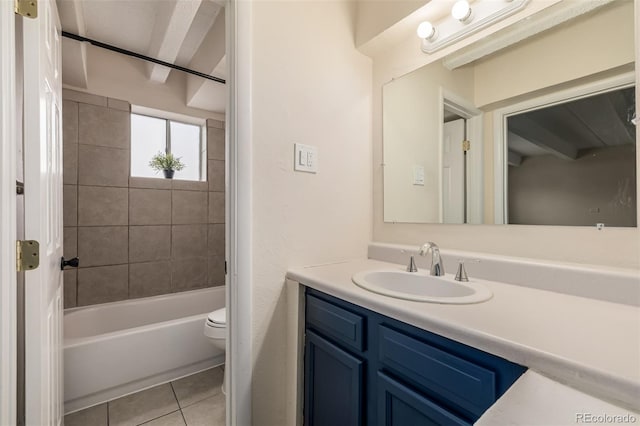 full bathroom with tiled shower / bath, toilet, tile patterned floors, and vanity