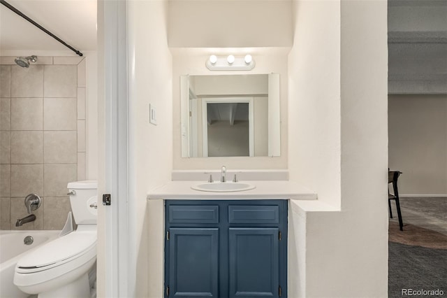 full bathroom with tiled shower / bath, vanity, and toilet