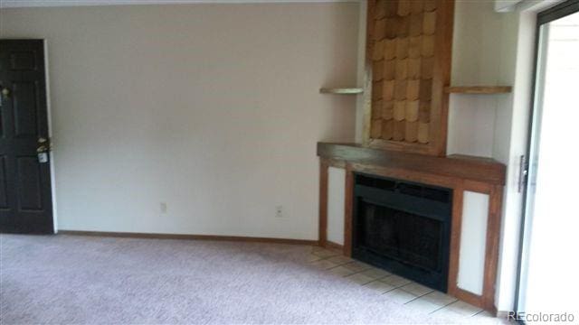 unfurnished living room with light colored carpet