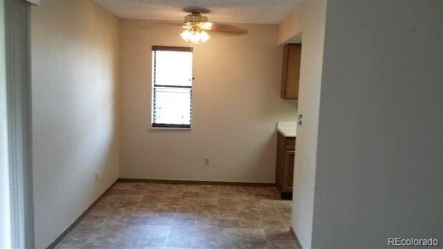 unfurnished dining area with ceiling fan