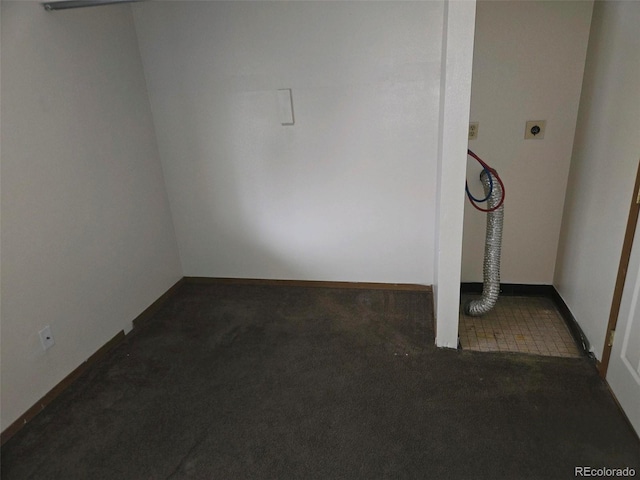 unfurnished room with dark colored carpet