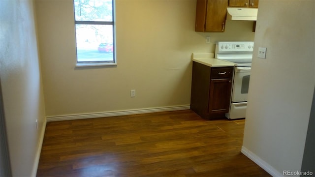 kitchen with white electric range oven and dark wood-type flooring