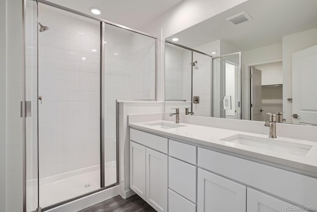 bathroom with vanity, a shower with door, and hardwood / wood-style flooring