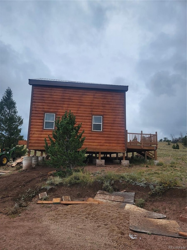 view of home's exterior with a wooden deck