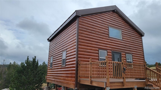 view of property exterior with a deck